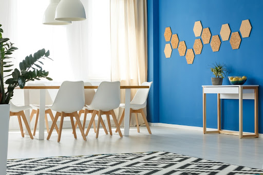A dining room with a blue accent wall